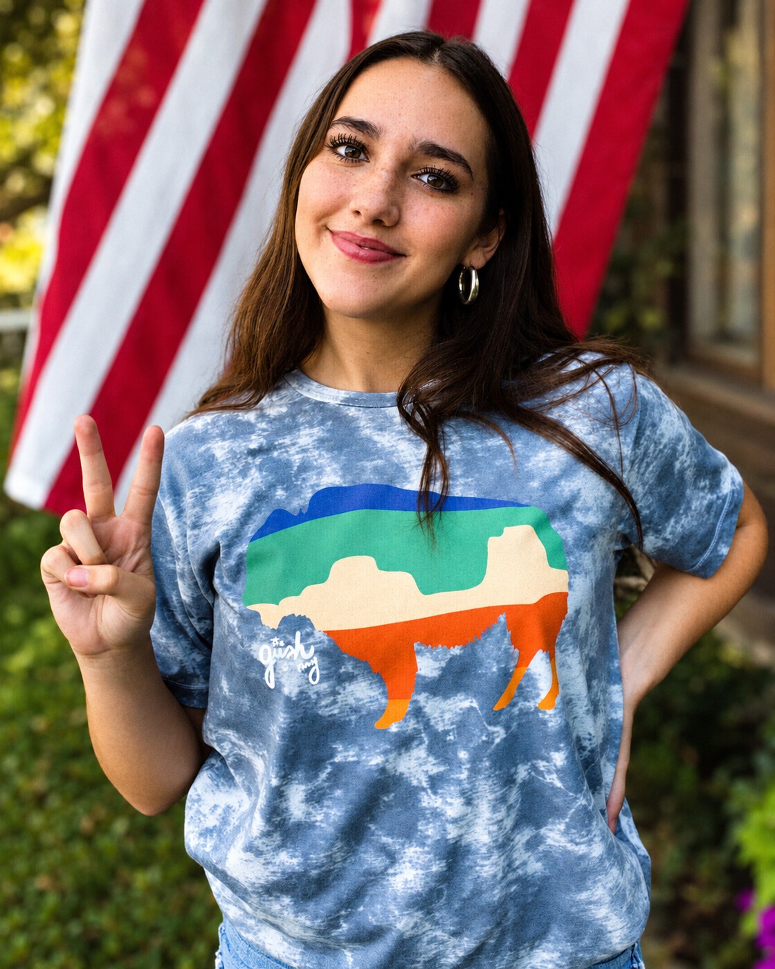 Buffalo tee portrait beside an American flag