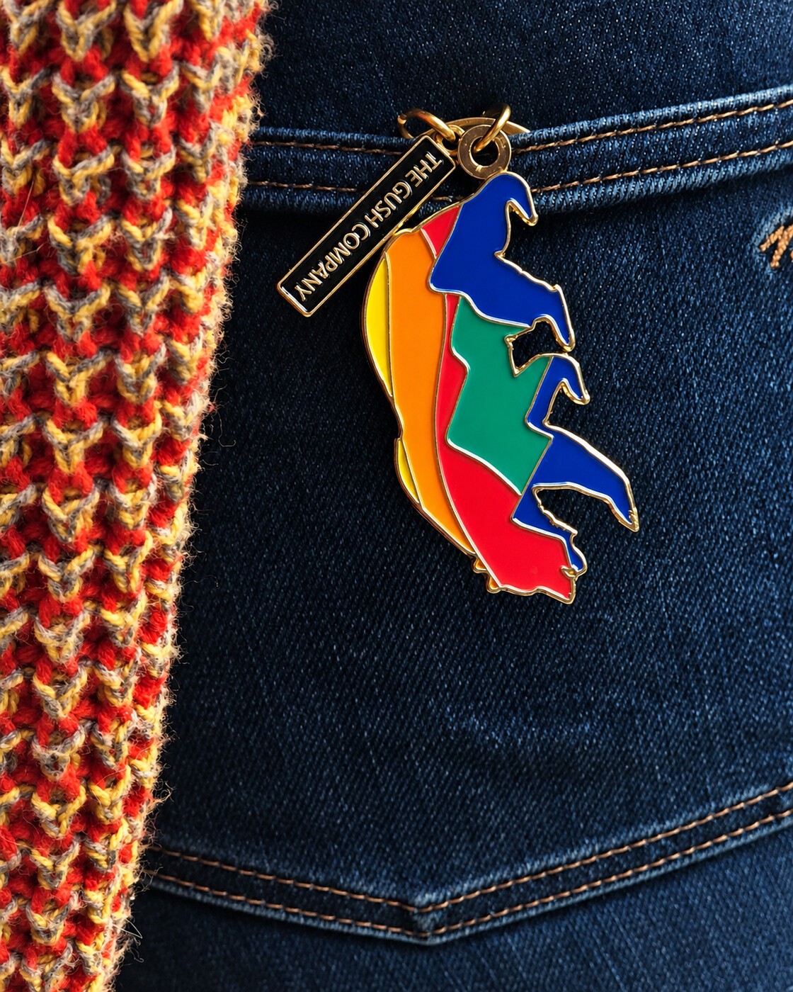 Enamel bear keychain against denim