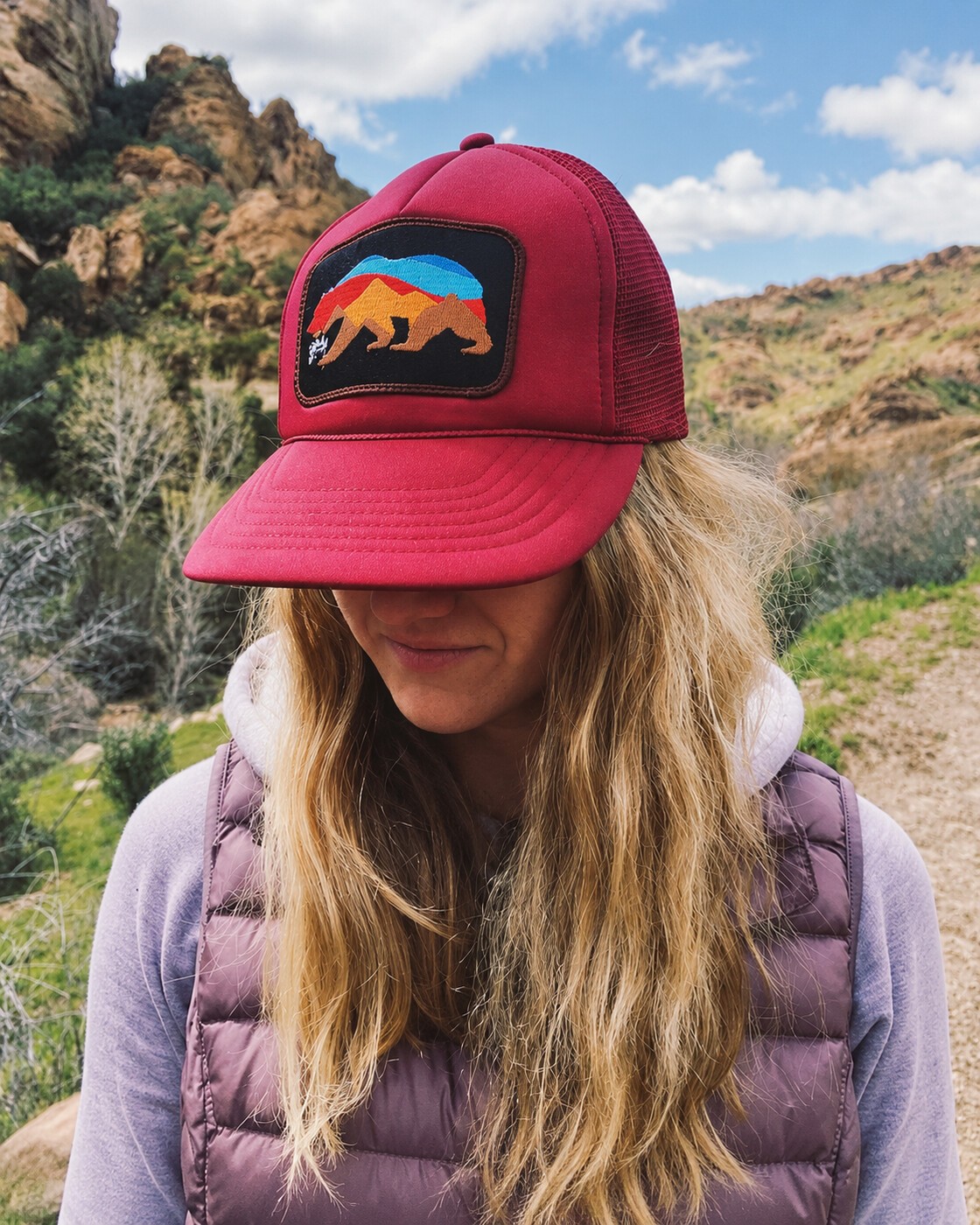 Red bear hat on a rocky trail