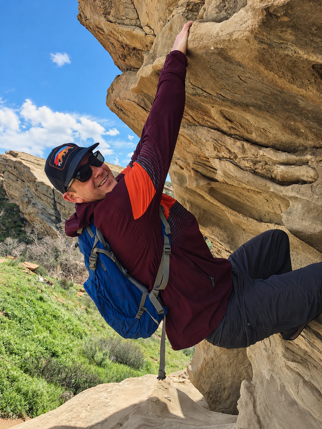 Climber wearing the Sunset Bear patch hat on a sandstone rock formation