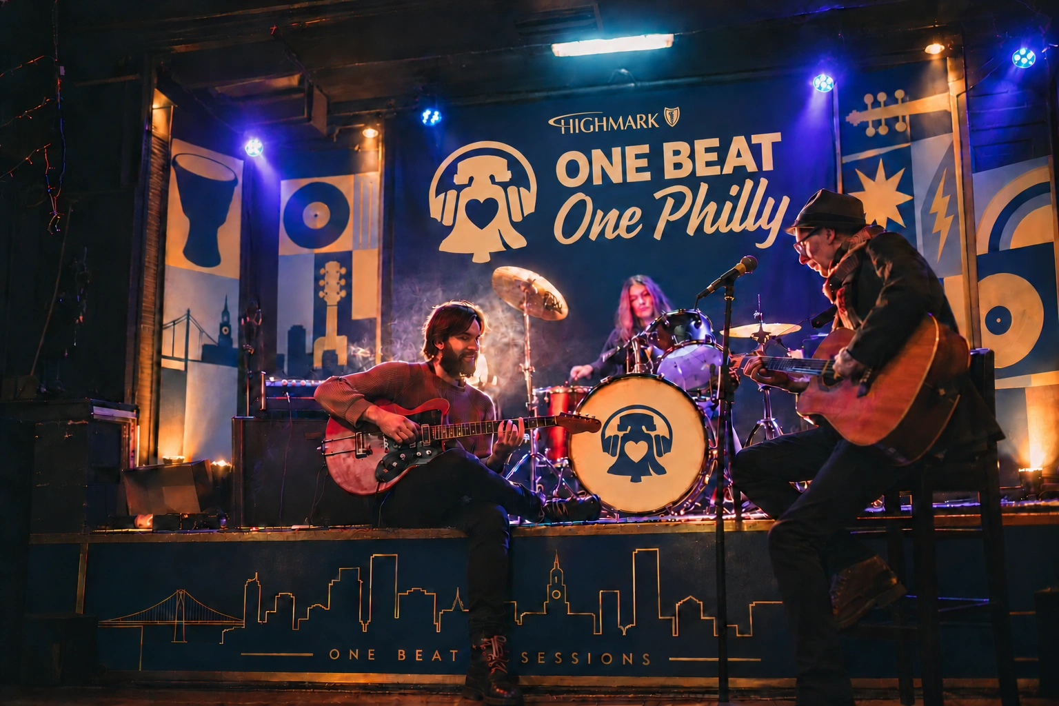 AI-generated One Beat Sessions stage concept with musicians, navy-and-gold One Beat One Philly backdrop, Highmark branding, bell logo on the kick drum and Philadelphia skyline stage graphics.